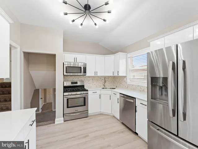 a kitchen with a refrigerator sink and stainless steel appliances