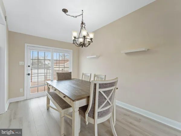 a view of a dining room with furniture wooden floor and chandelier