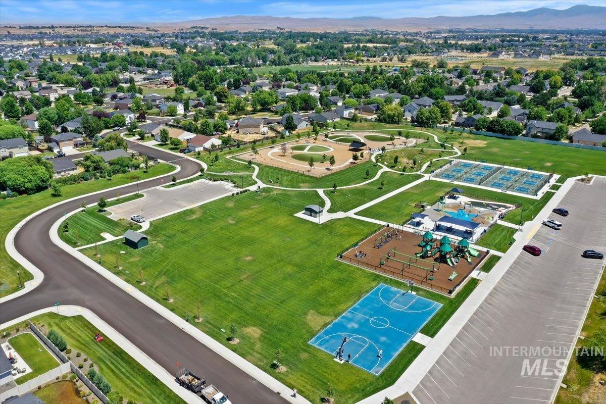 12310 West Hidden Point Drive Star, ID 83669 - Photo 45 of 48 Expansive recreational park featuring multiple sports courts, a playground, and open green spaces