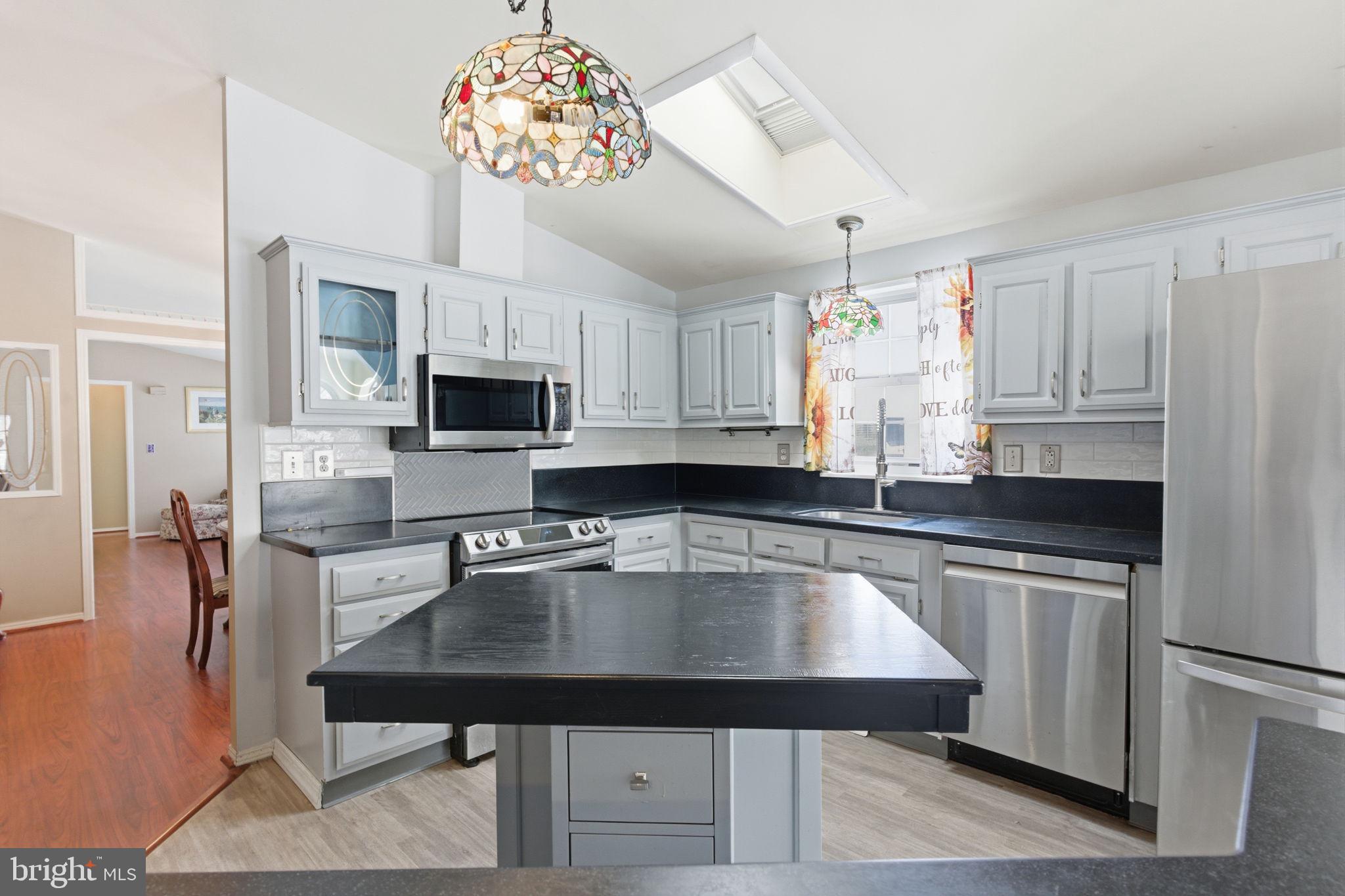 435 Spring Meadow Circle New Hope, PA 18938 - Photo 12 of 38 a kitchen with a sink a microwave and cabinets
