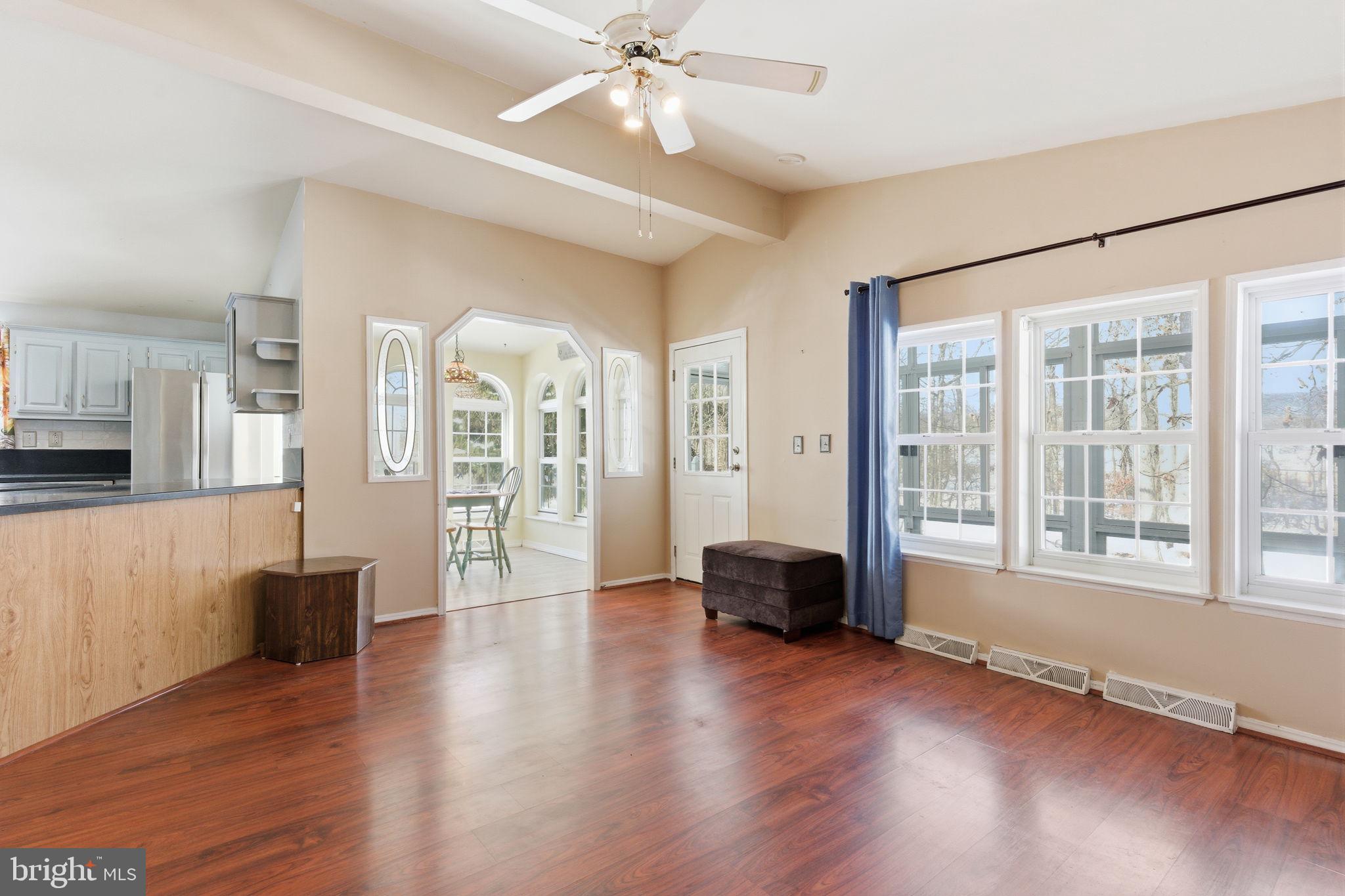 435 Spring Meadow Circle New Hope, PA 18938 - Photo 16 of 38 a view of an empty room with wooden floor and a window