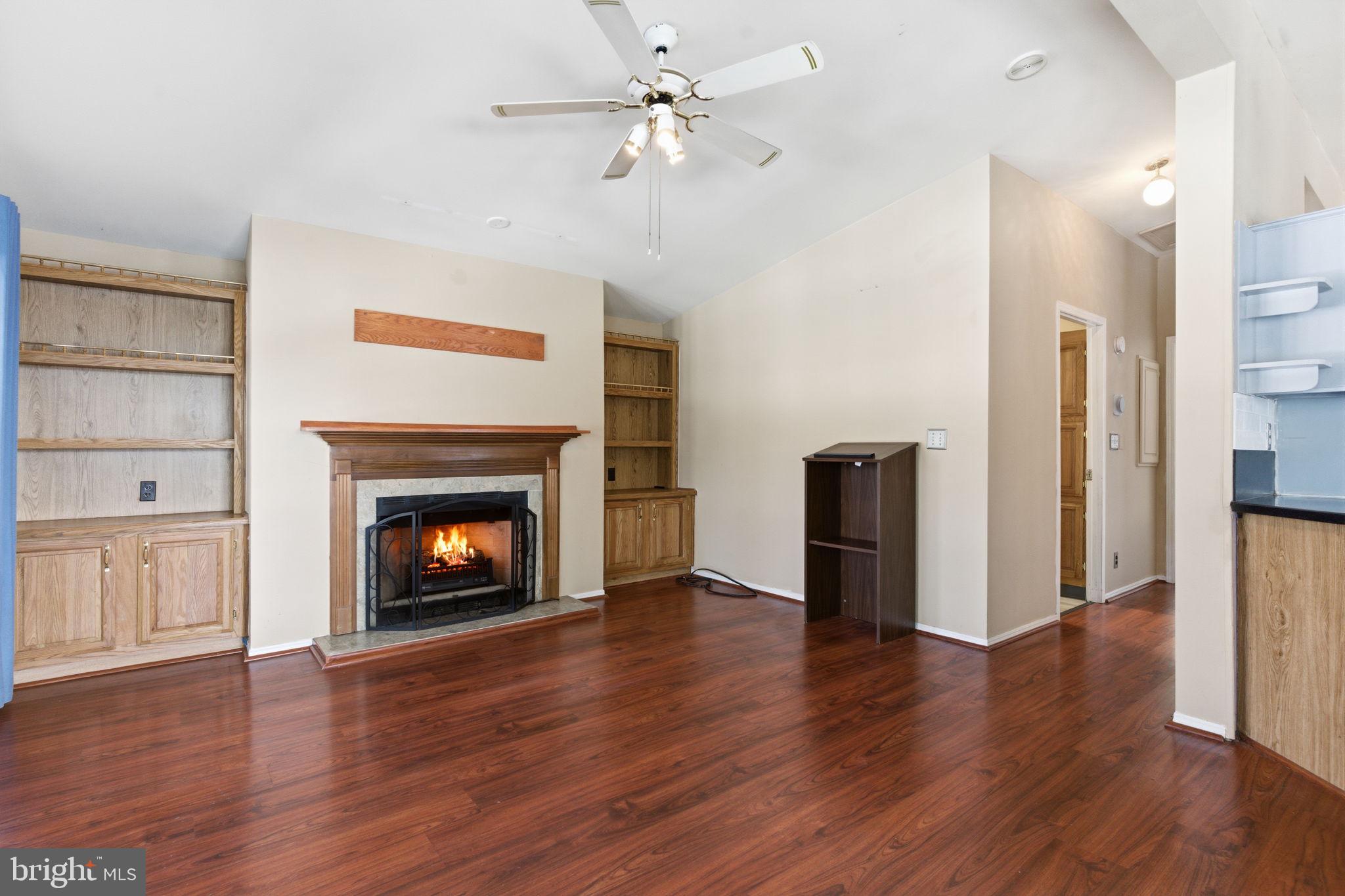 435 Spring Meadow Circle New Hope, PA 18938 - Photo 17 of 38 a view of an empty room with wooden floor a fireplace and a window