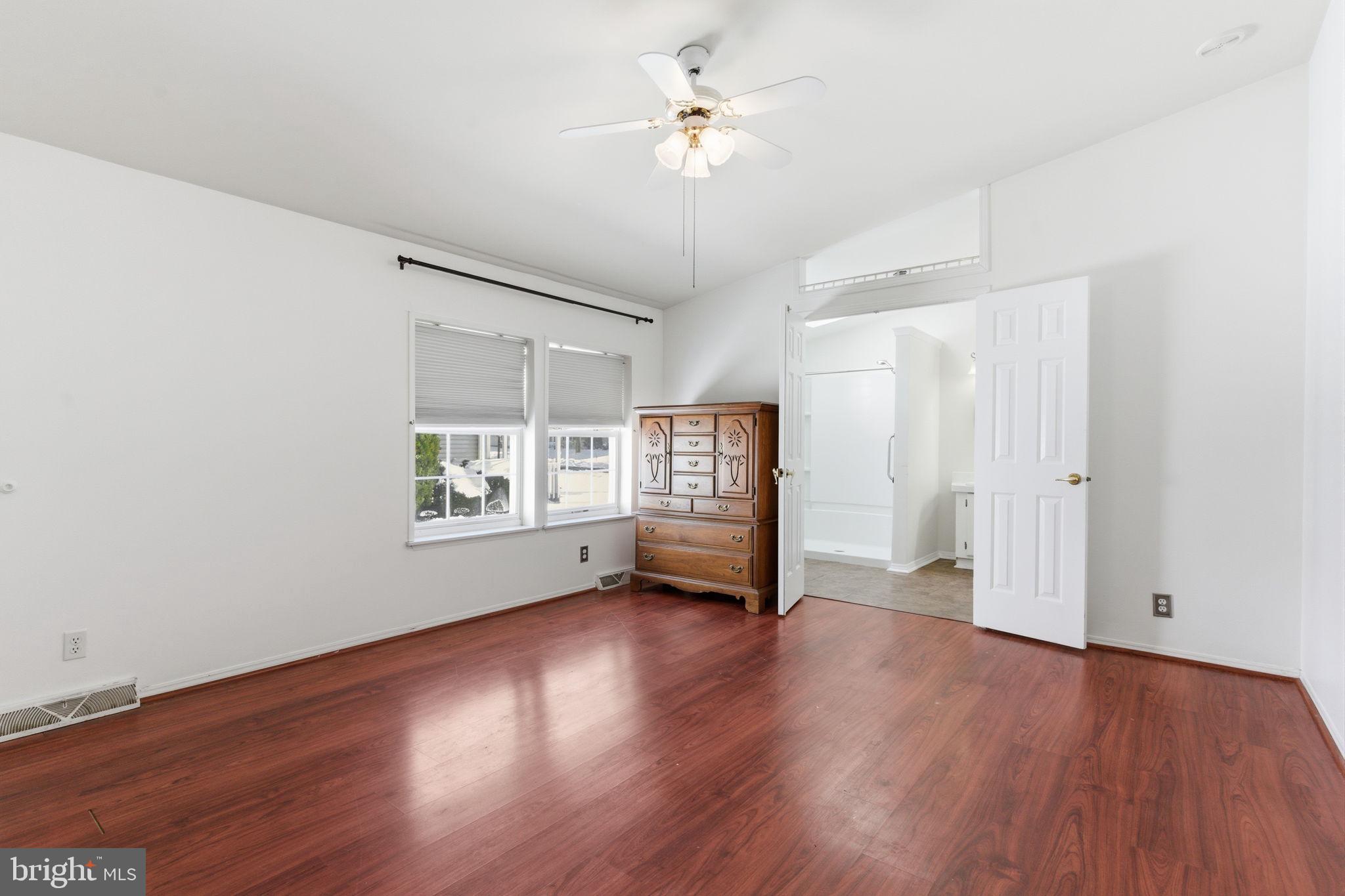 435 Spring Meadow Circle New Hope, PA 18938 - Photo 18 of 38 a view of an empty room with a window and wooden floor