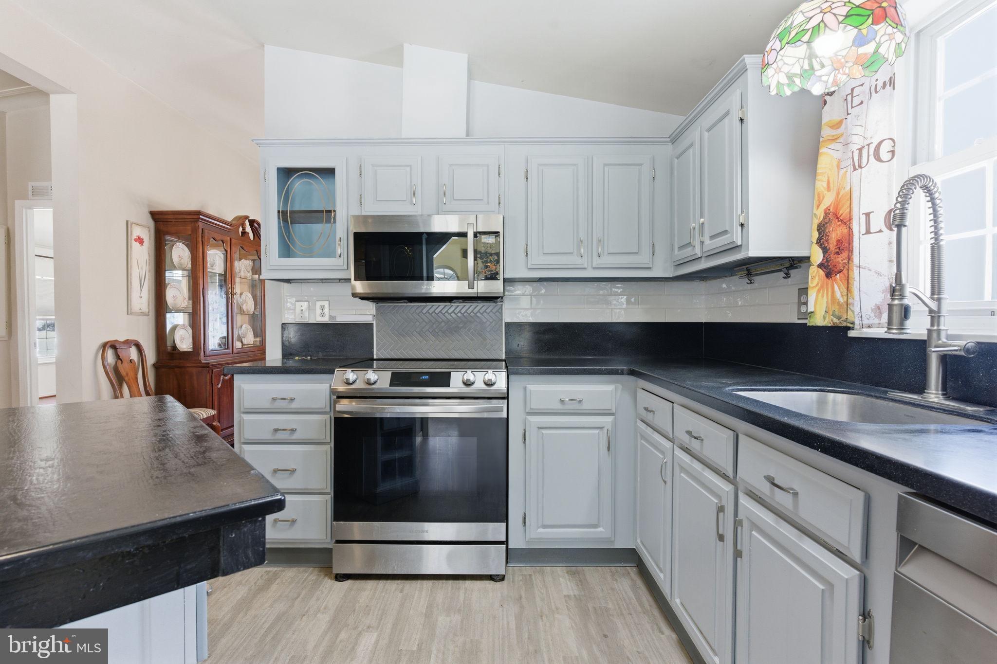 435 Spring Meadow Circle New Hope, PA 18938 - Photo 8 of 38 a kitchen with white cabinets stainless steel appliances and sink