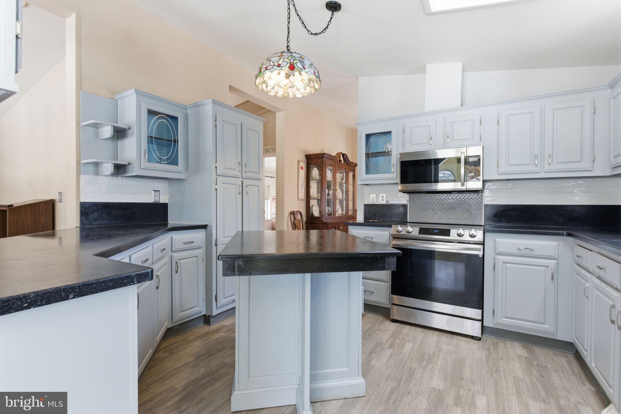 435 Spring Meadow Circle New Hope, PA 18938 - Photo 9 of 38 a kitchen with stainless steel appliances granite countertop a sink stove and refrigerator