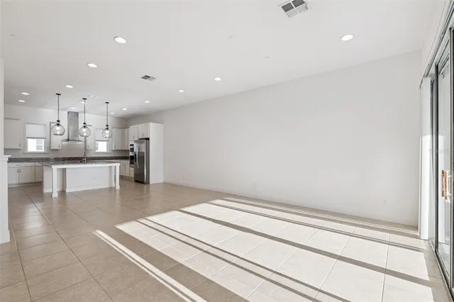 a view of kitchen with refrigerator and window