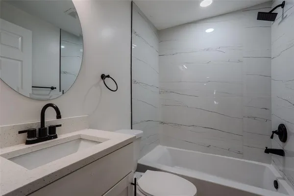 a bathroom with a sink a toilet and bathtub