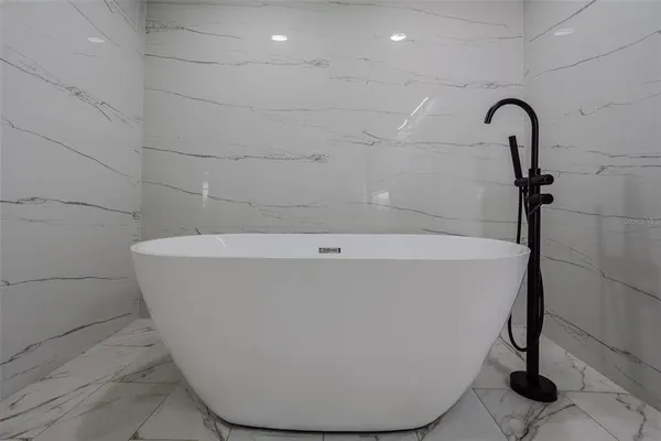 a white bath tub sitting in a bathroom
