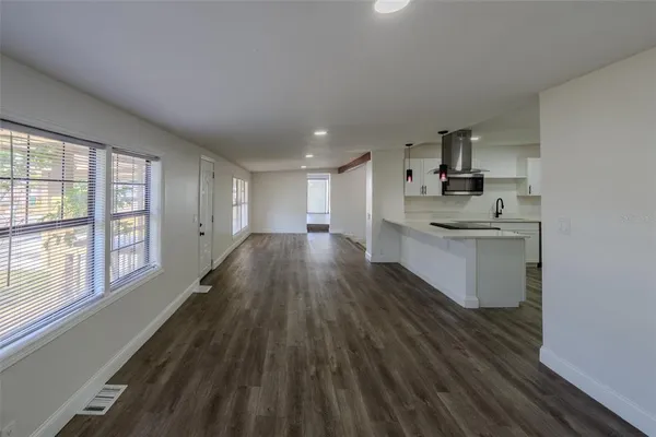 a kitchen with a sink and wooden floor
