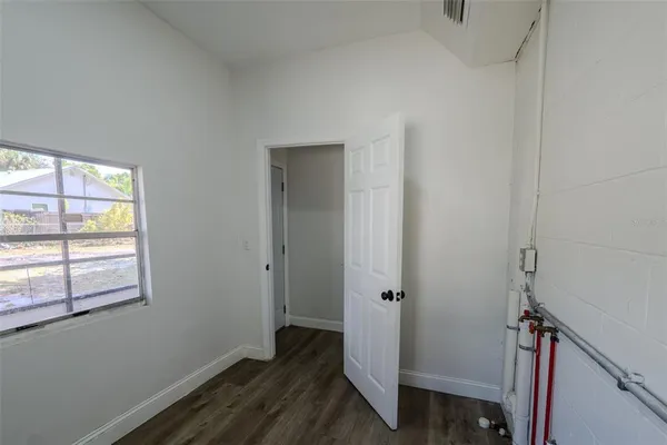 a view of room with window and wooden floor
