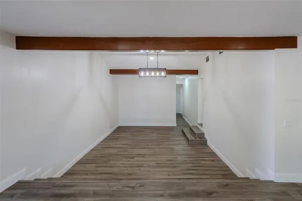 a view of a room with wooden floor