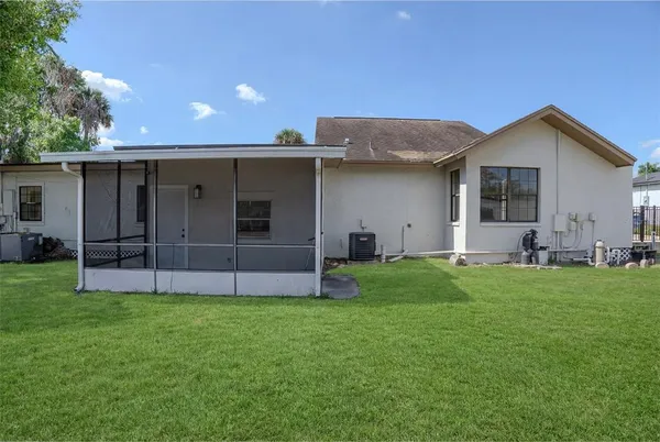 a view of a house with a yard and front view of a house