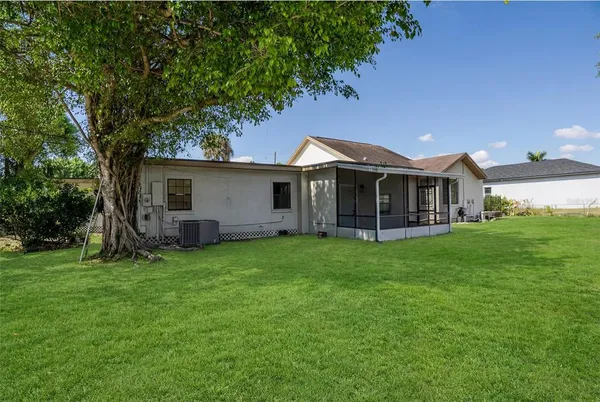 a view of a house with a backyard