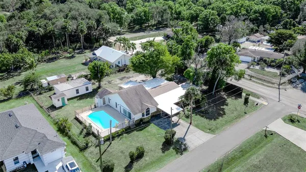 an aerial view of a house with a yard basket ball court and outdoor seating