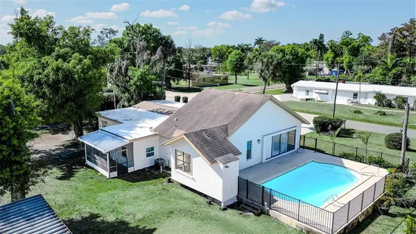 an aerial view of a house with a big yard