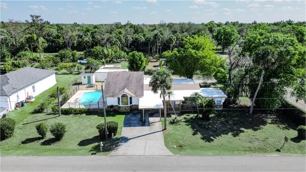 an aerial view of a house with yard