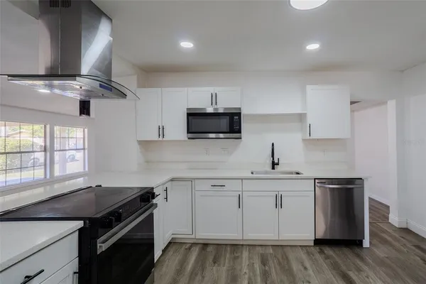 a kitchen with a sink stove and cabinets