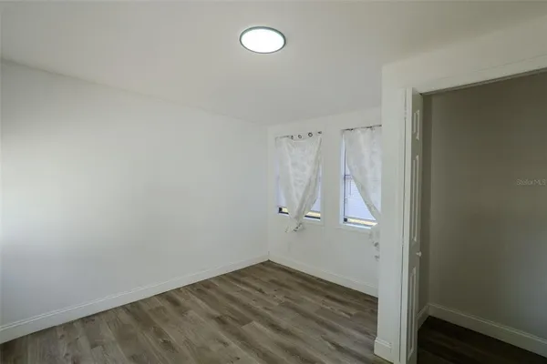 a view of room with wooden floor