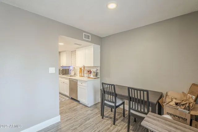 a view of a livingroom with furniture and kitchen view