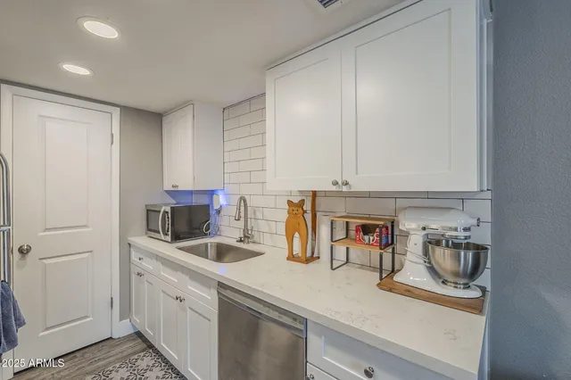 a kitchen with a sink and a refrigerator