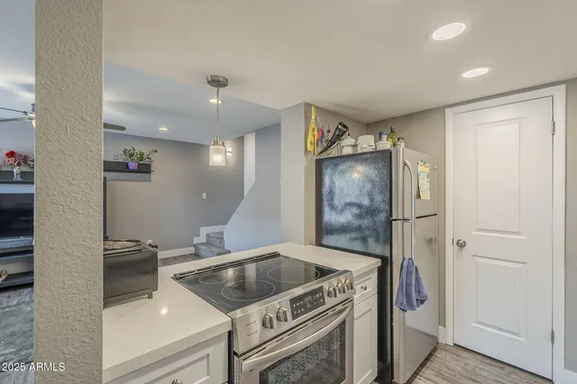 a kitchen with granite countertop a sink stove and refrigerator