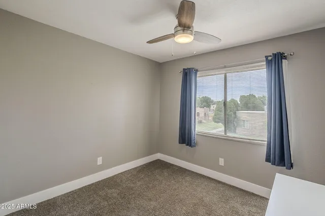 a view of room with window and ceiling fan