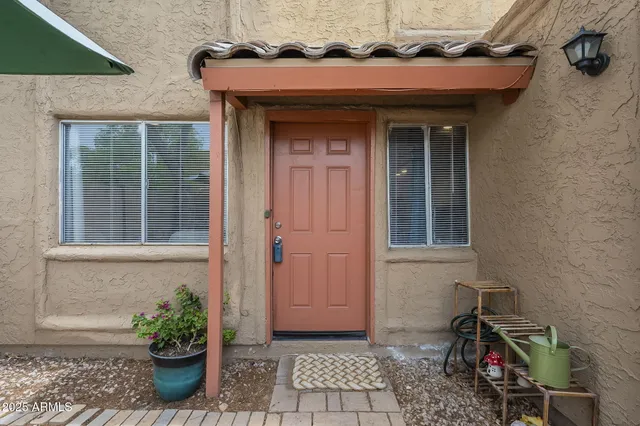 a view of a house with potted plants