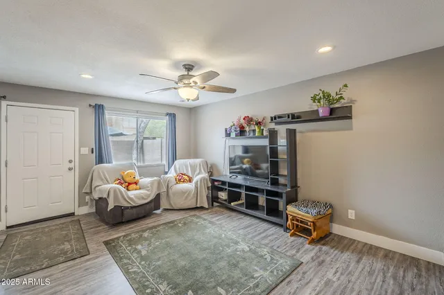 a living room with furniture and wooden floor