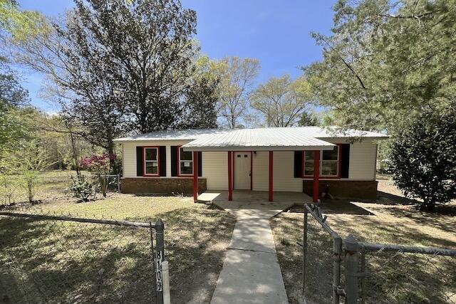 8106 County Line Road Laurel Hill, FL 32567 - Photo 1 of 13 a view of a house with a yard covered in snow
