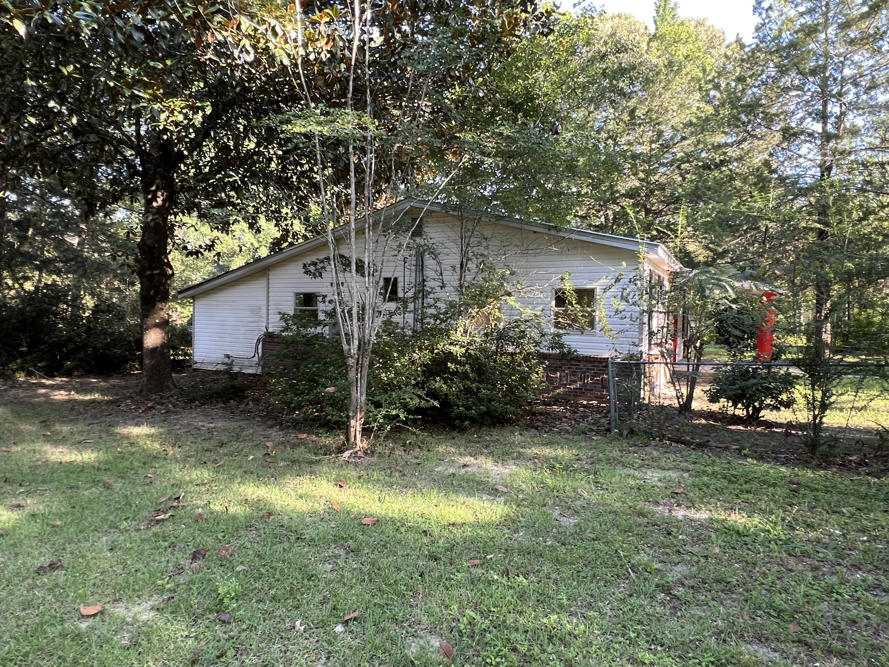 8106 County Line Road Laurel Hill, FL 32567 - Photo 12 of 13 a view of a house with a yard