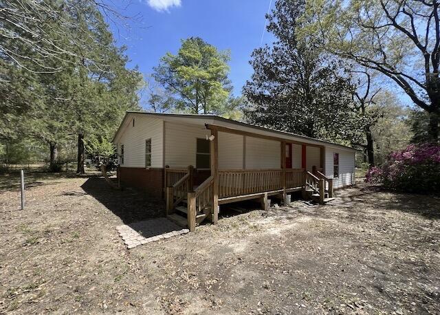 8106 County Line Road Laurel Hill, FL 32567 - Photo 13 of 13 a view of a house with a yard and tree