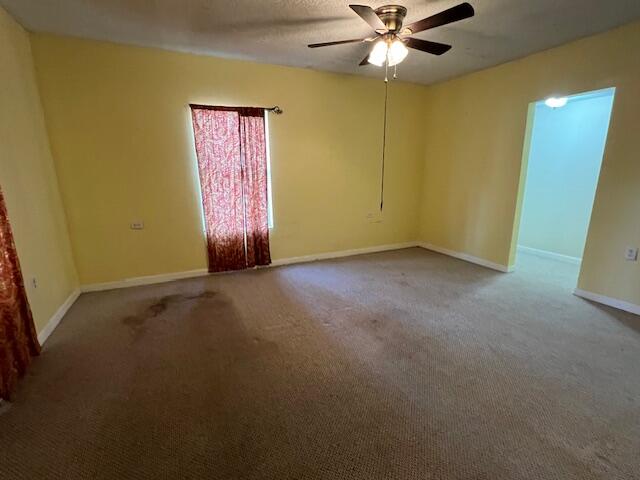 8106 County Line Road Laurel Hill, FL 32567 - Photo 5 of 13 an empty room with a ceiling fan and a window