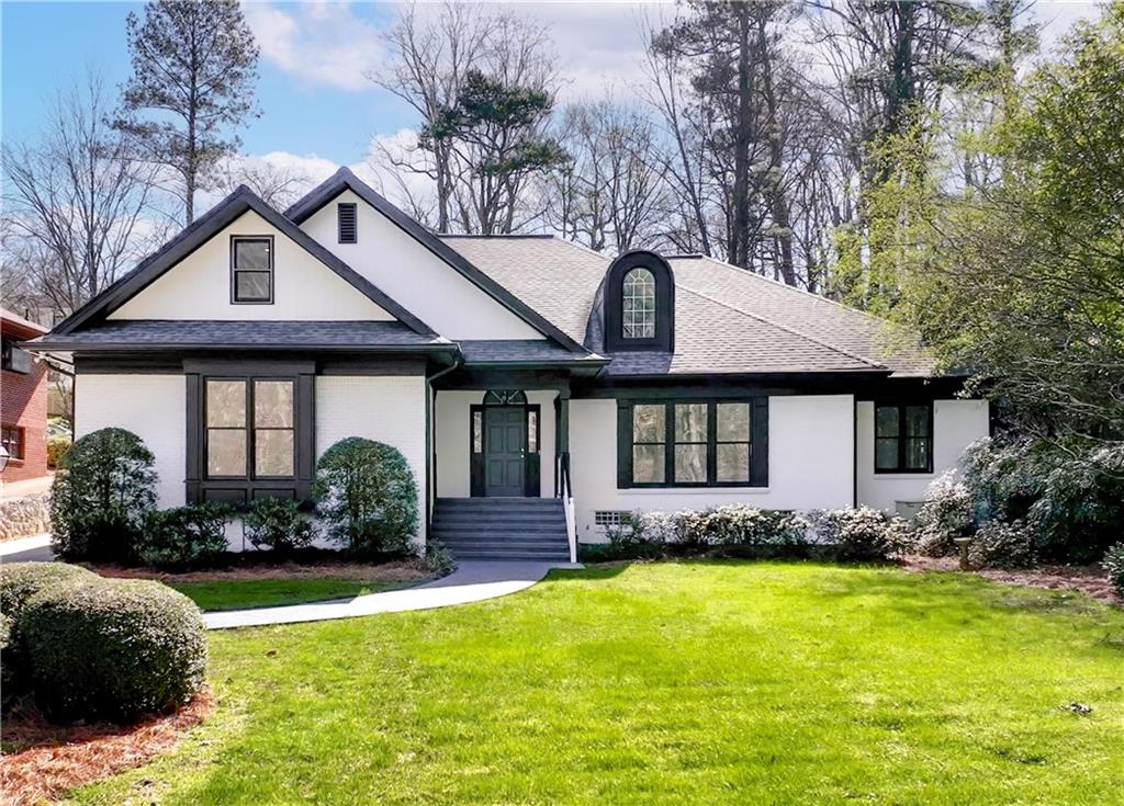 1745 Lenox Road Northeast Atlanta, GA 30306 - Photo 1 of 1 a front view of a house with swimming pool having outdoor seating