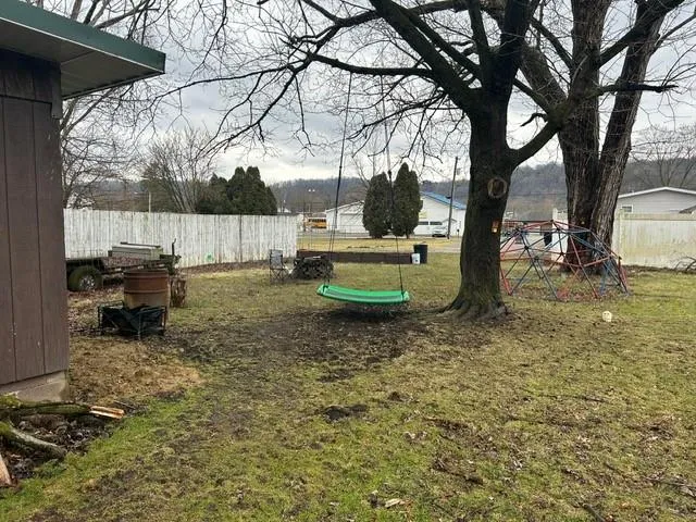 a backyard of a house with fire pit and furniture