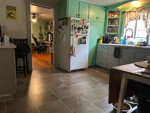 a kitchen with refrigerator and window