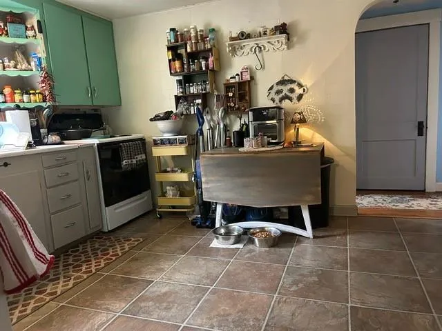 a kitchen with a stove a sink and a microwave