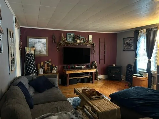 a bedroom with a bed and a flat tv screen on dresser