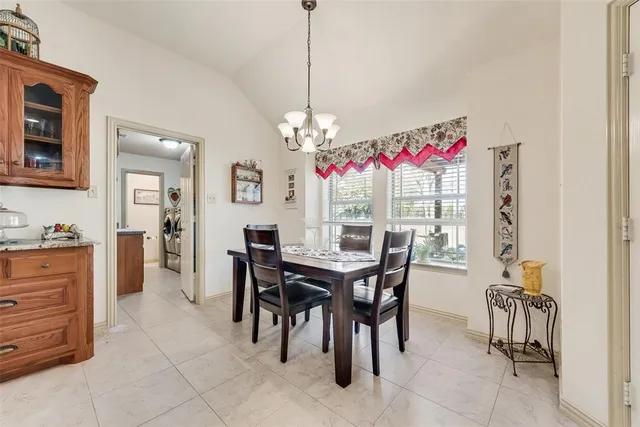 a view of a dining room with furniture and chandelier