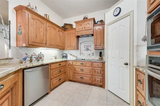 a kitchen with stainless steel appliances granite countertop a refrigerator sink and cabinets