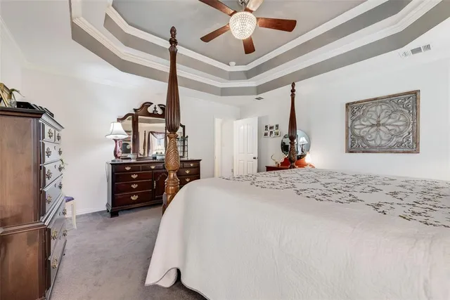 a bed room with a bed and a ceiling fan