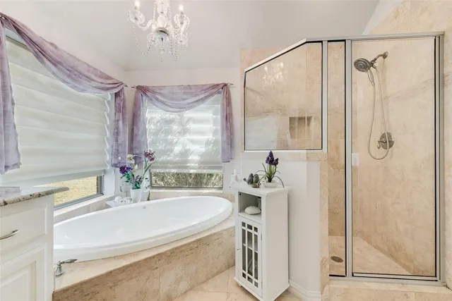 a bathroom with a tub sink and mirror