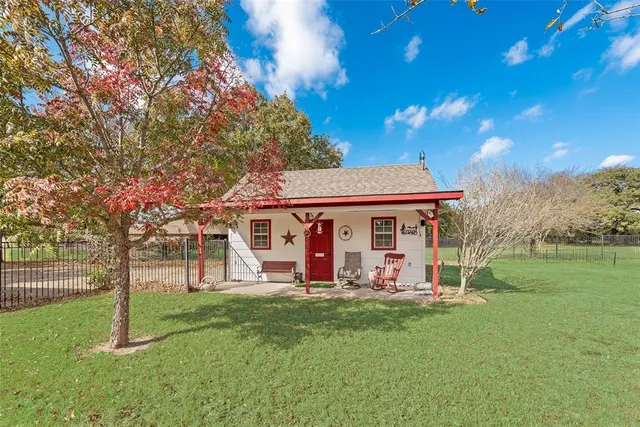 a front view of house with yard and green space