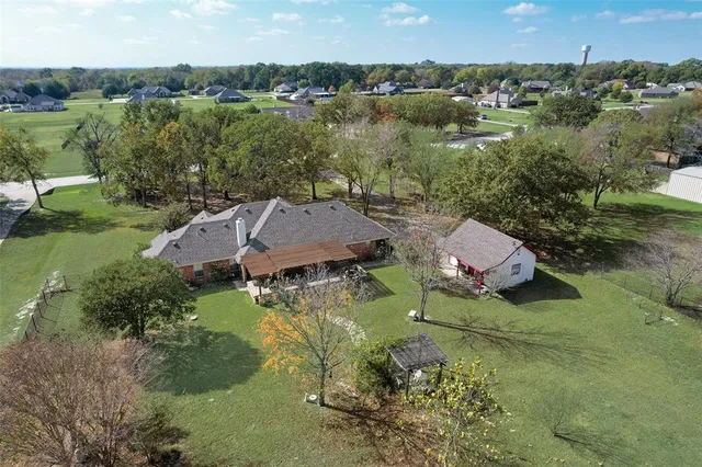 an aerial view of a house with a yard