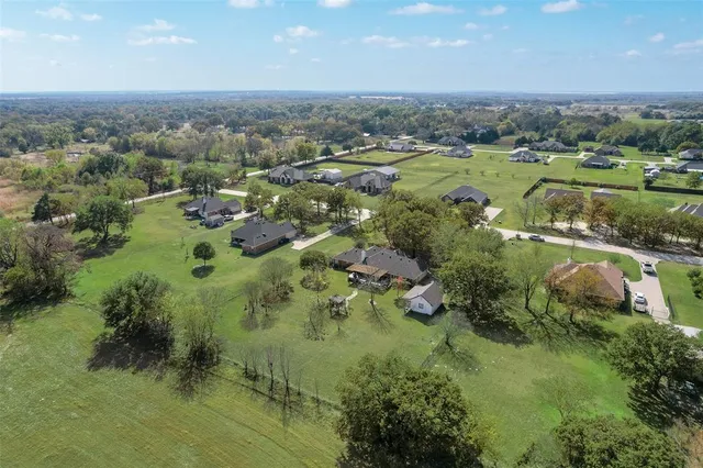 an aerial view of residential houses with outdoor space and river