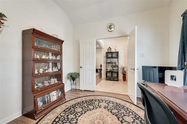 a living room with furniture and a book shelf