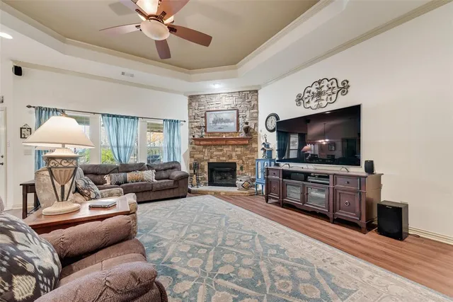 a living room with furniture a flat screen tv and a fireplace