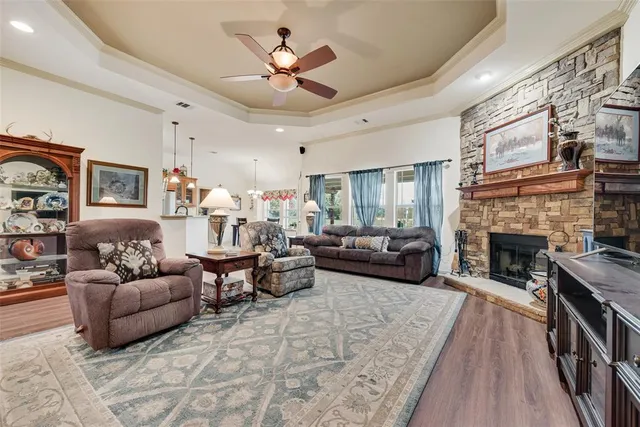 a living room with furniture a fireplace and a flat screen tv