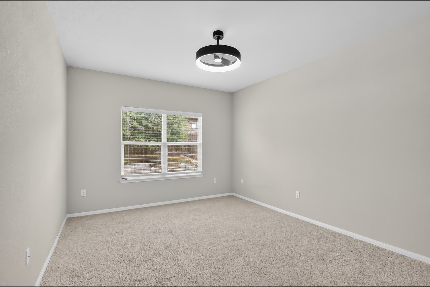 2006 Grow Lane Austin, TX 78754 - Photo 12 of 40 A well-lit bedroom features plush carpeting and a modern ceiling fan, inviting personalization.