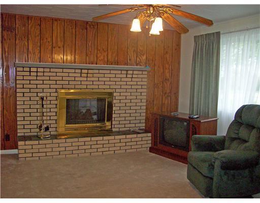 3359 Country Club Road Mount Pleasant, PA 15666 - Photo 2 of 9 Living Room. Shows brick wood burning fire place.