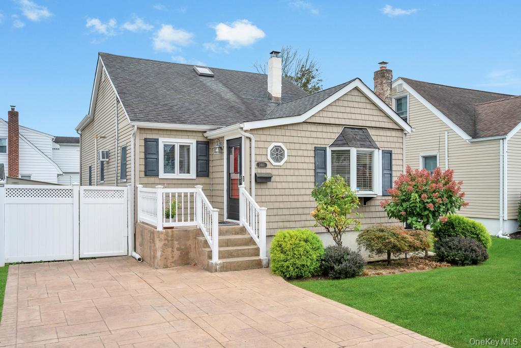 View of front of home featuring roof with shingles and a chimney